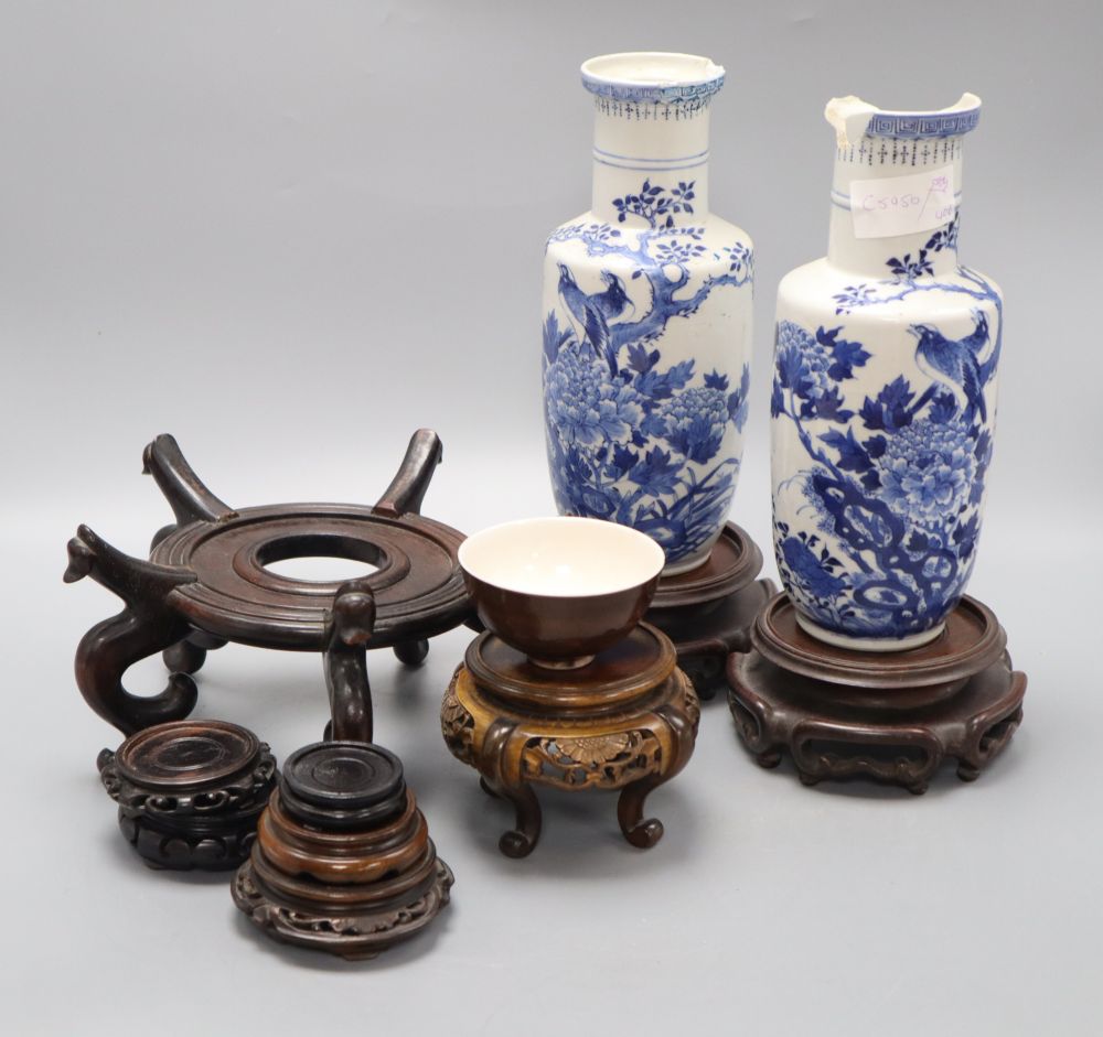 A pair of Chinese blue and white vases, a teabowl and a collection of wooden stands